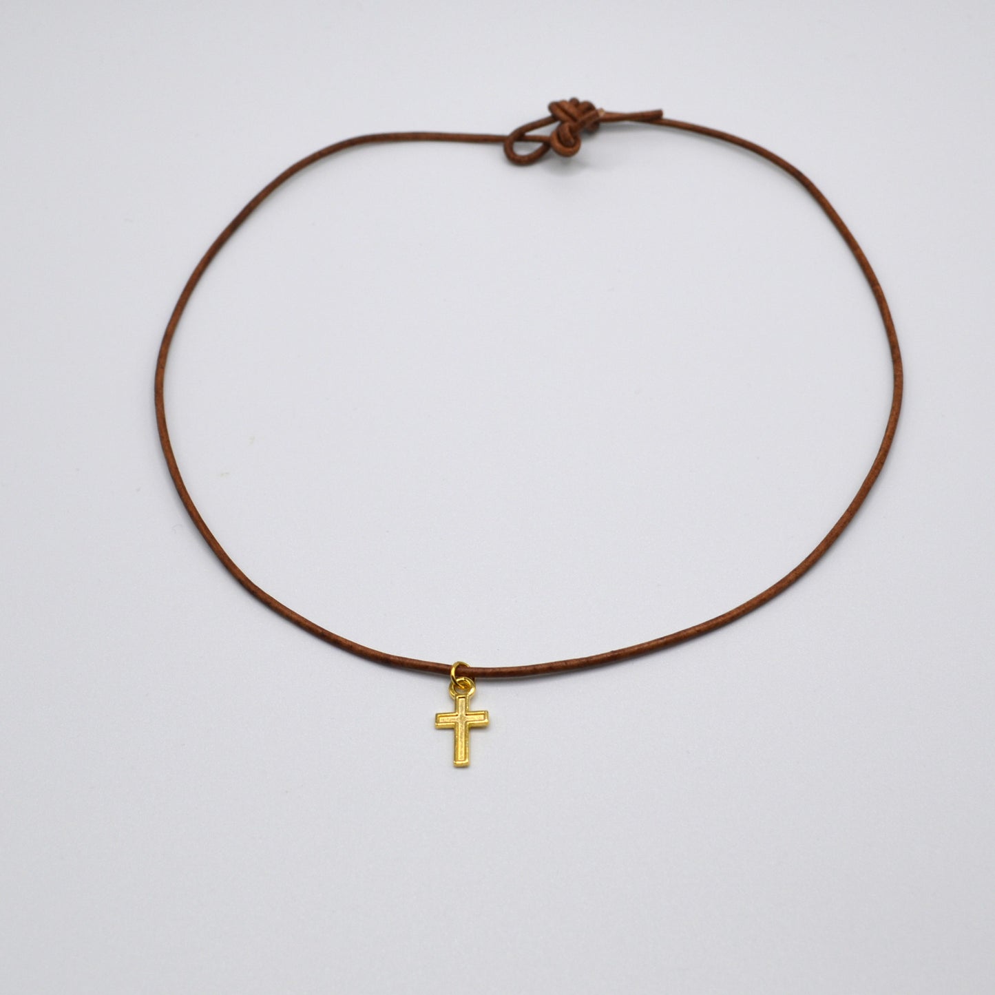 Gold Cross on a Leather Cord