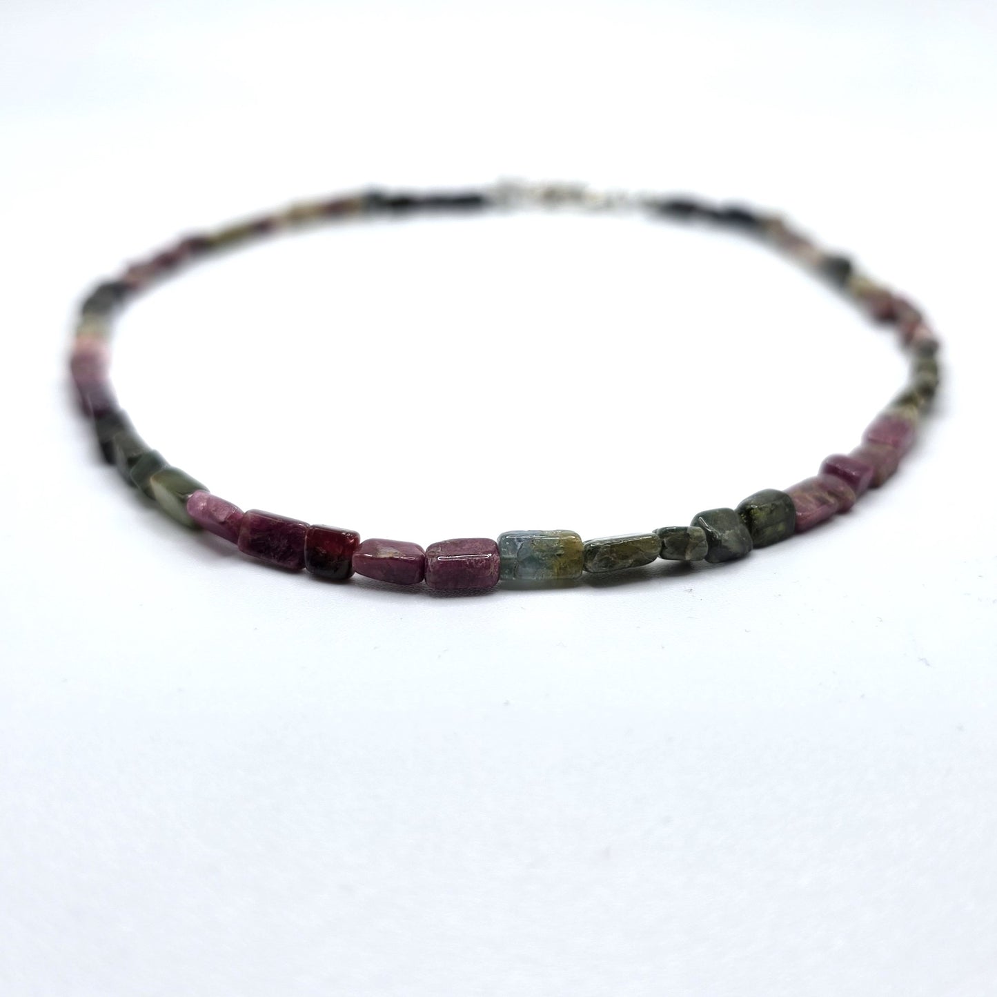 Necklace with pink and green tourmaline beads on a white background