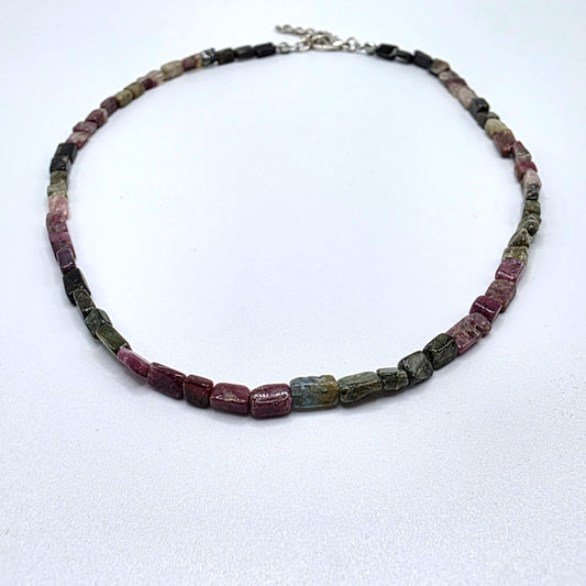 Necklace with pink and green tourmaline beads on a white background