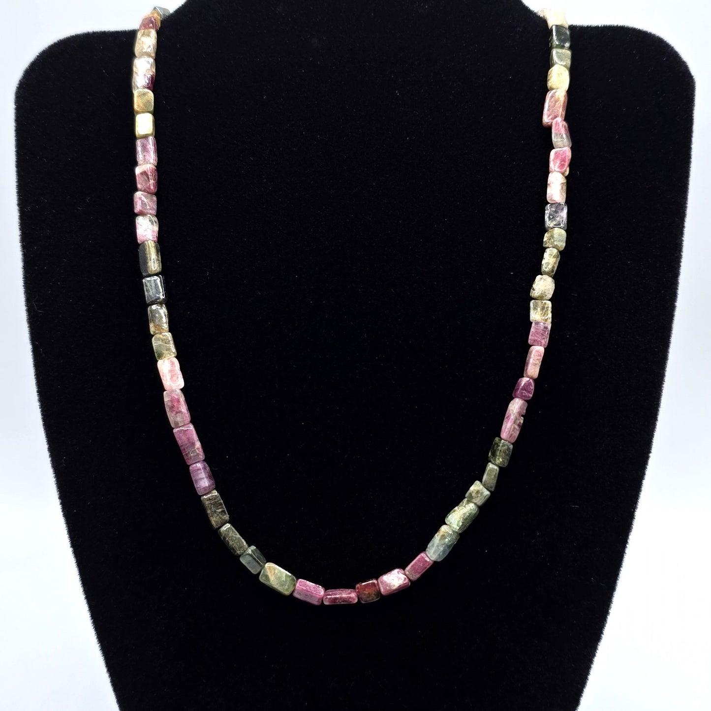 Necklace with pink and green tourmaline beads on a white background