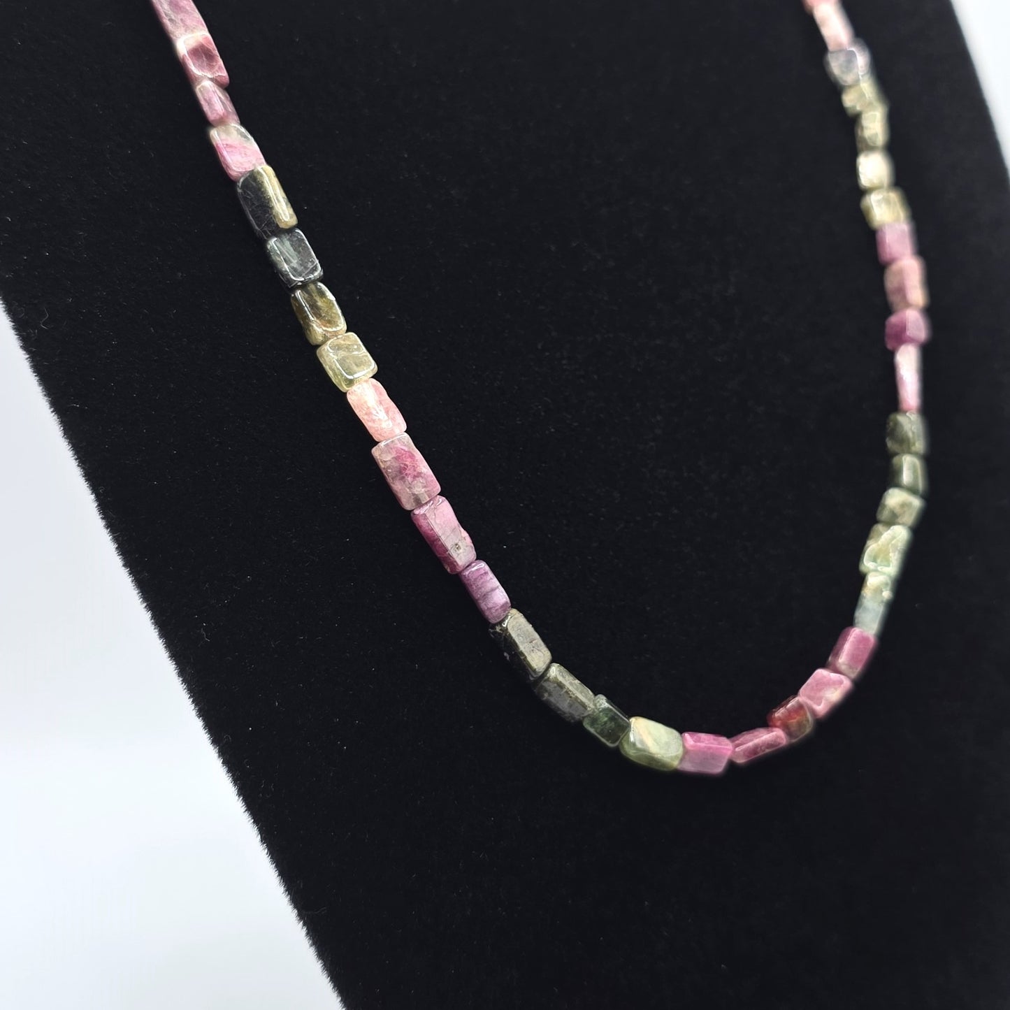 Necklace with pink and green tourmaline beads on a white background