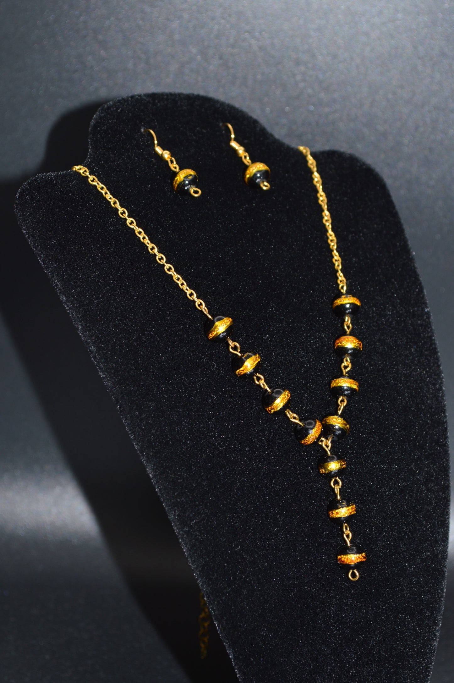 Black with a Gold Stripe Glass Beads on a Gold Chain Necklace