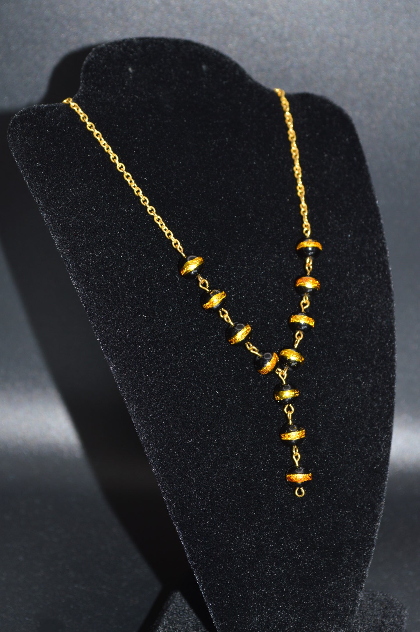 Black with a Gold Stripe Glass Beads on a Gold Chain Necklace