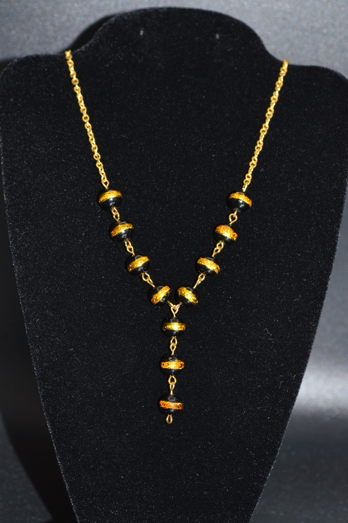 Black with a Gold Stripe Glass Beads on a Gold Chain Necklace