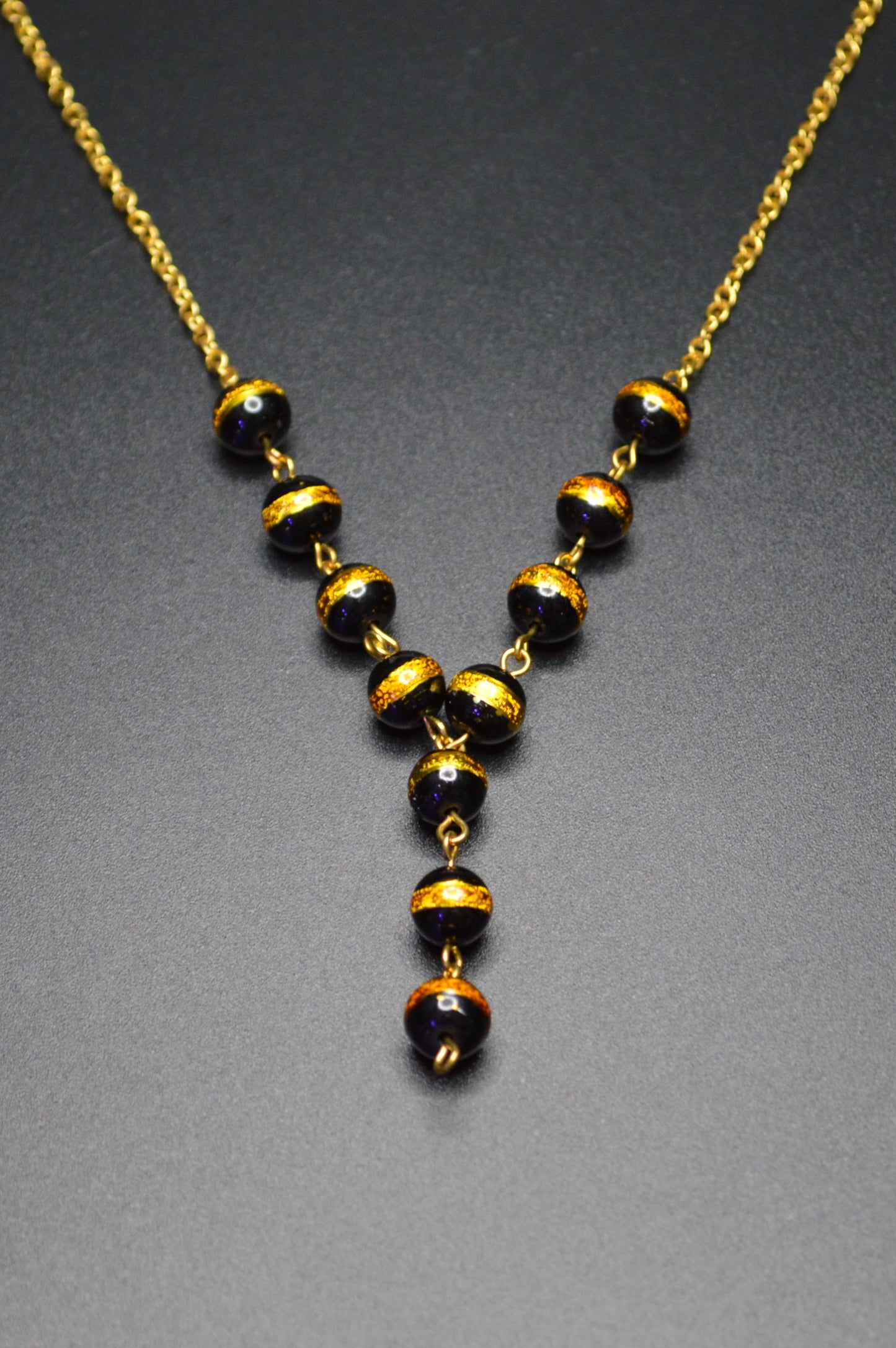 Black with a Gold Stripe Glass Beads on a Gold Chain Necklace