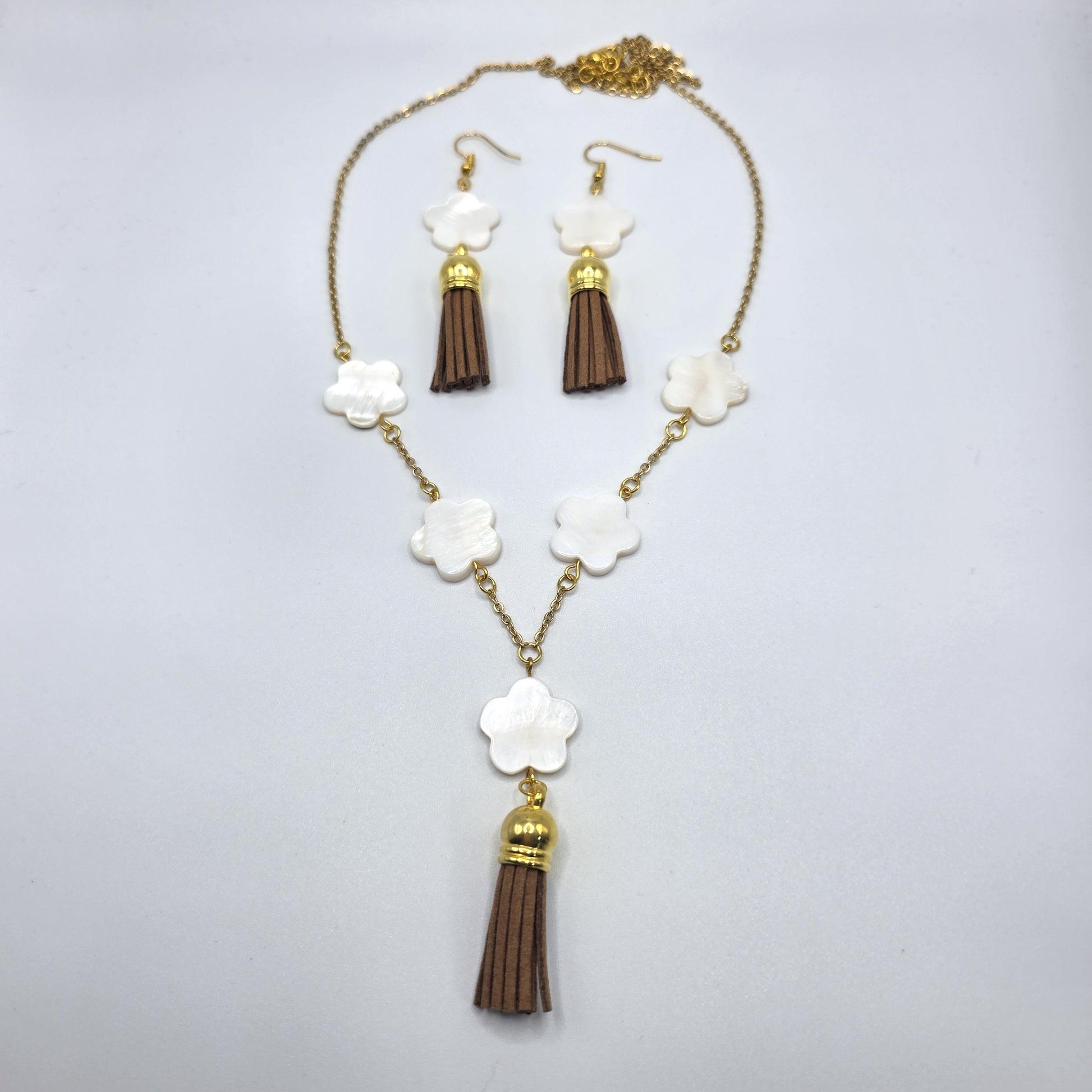 Jewelry set with necklace and earrings on a light gray background