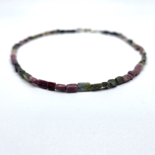Necklace with pink and green tourmaline beads on a white background