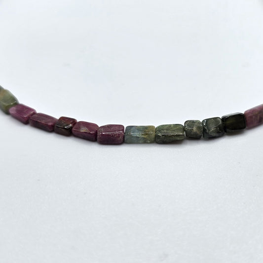 Necklace with pink and green tourmaline beads on a white background