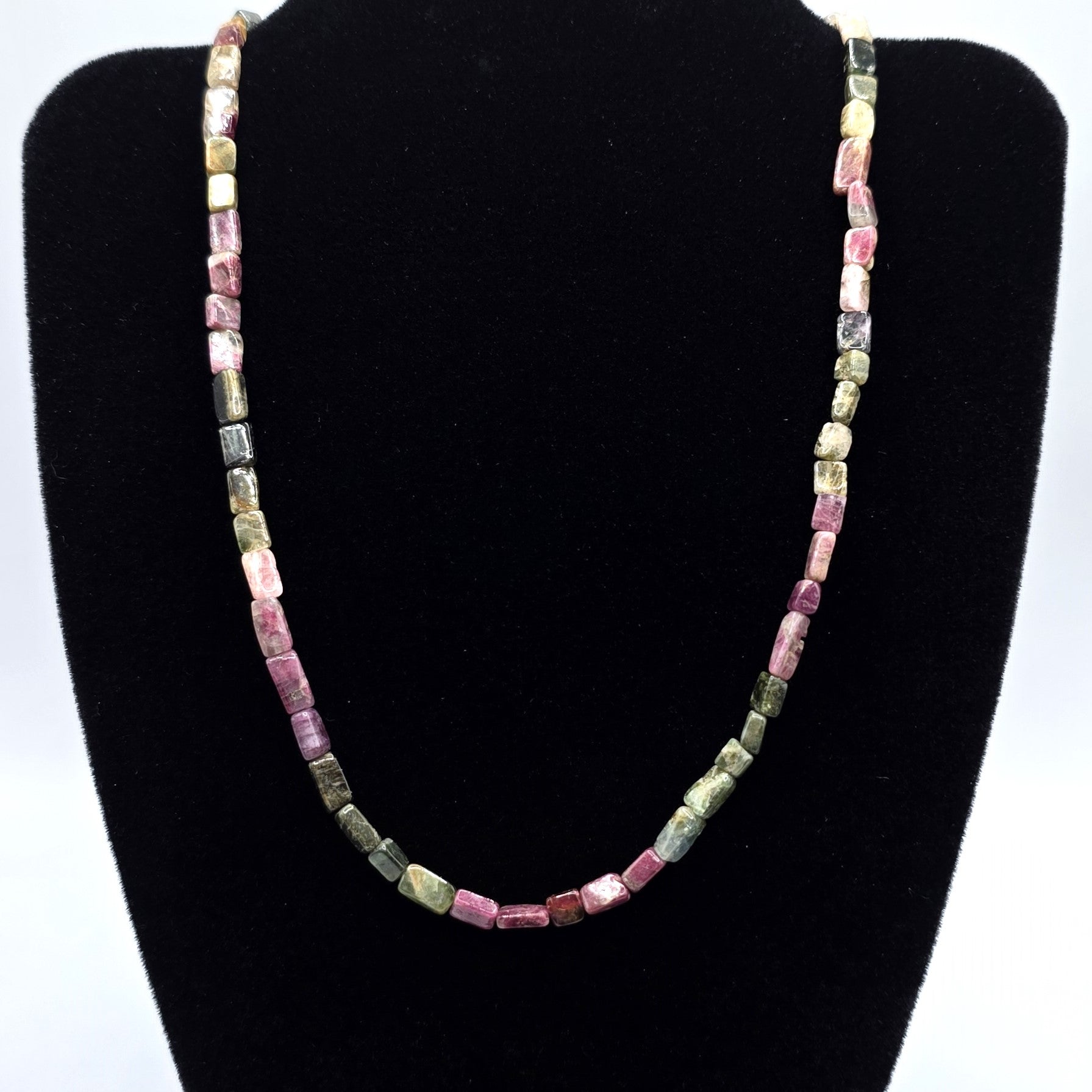 Necklace with pink and green tourmaline beads on a white background