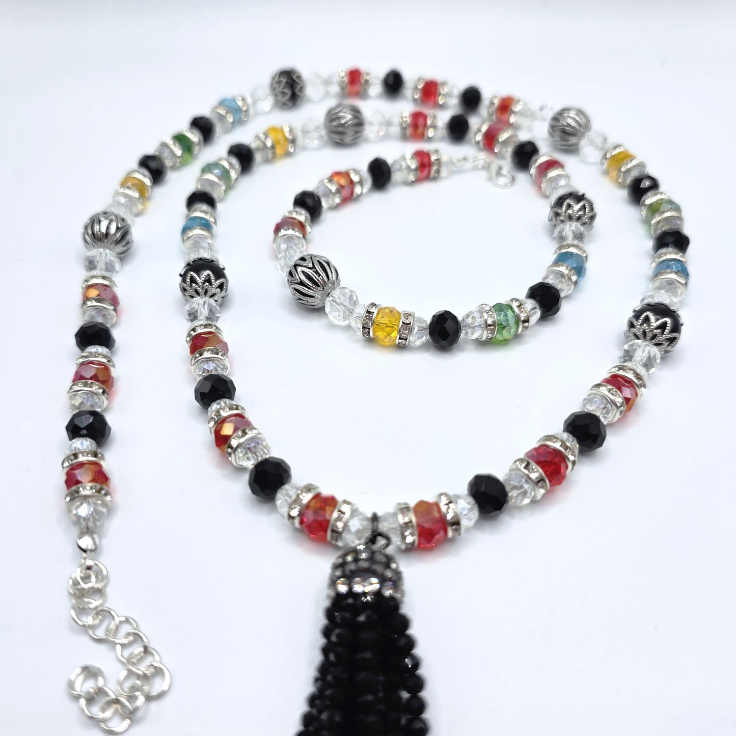 Colorful beaded necklace with a tassel on a white background