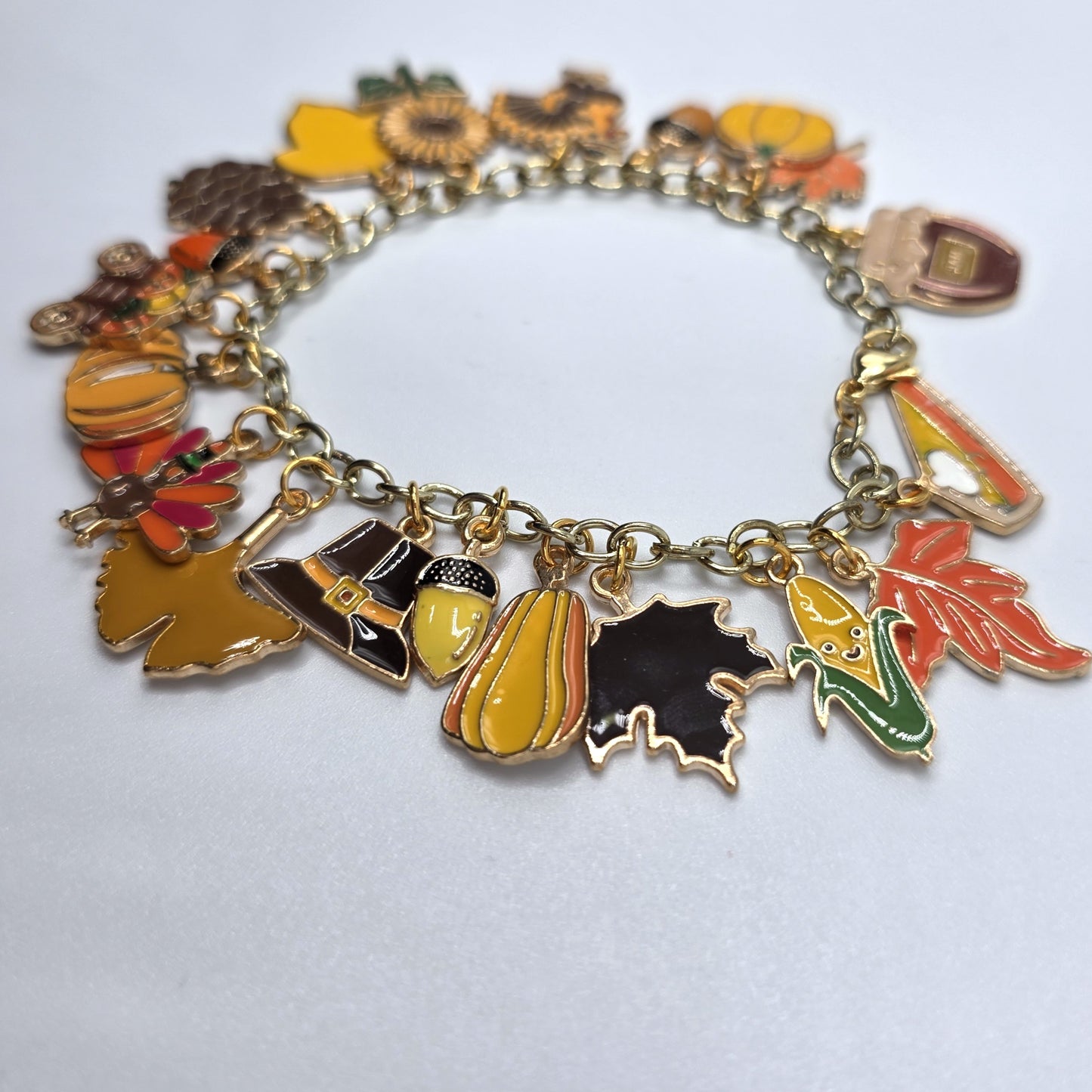 Bracelet with autumn-themed charms on a white background