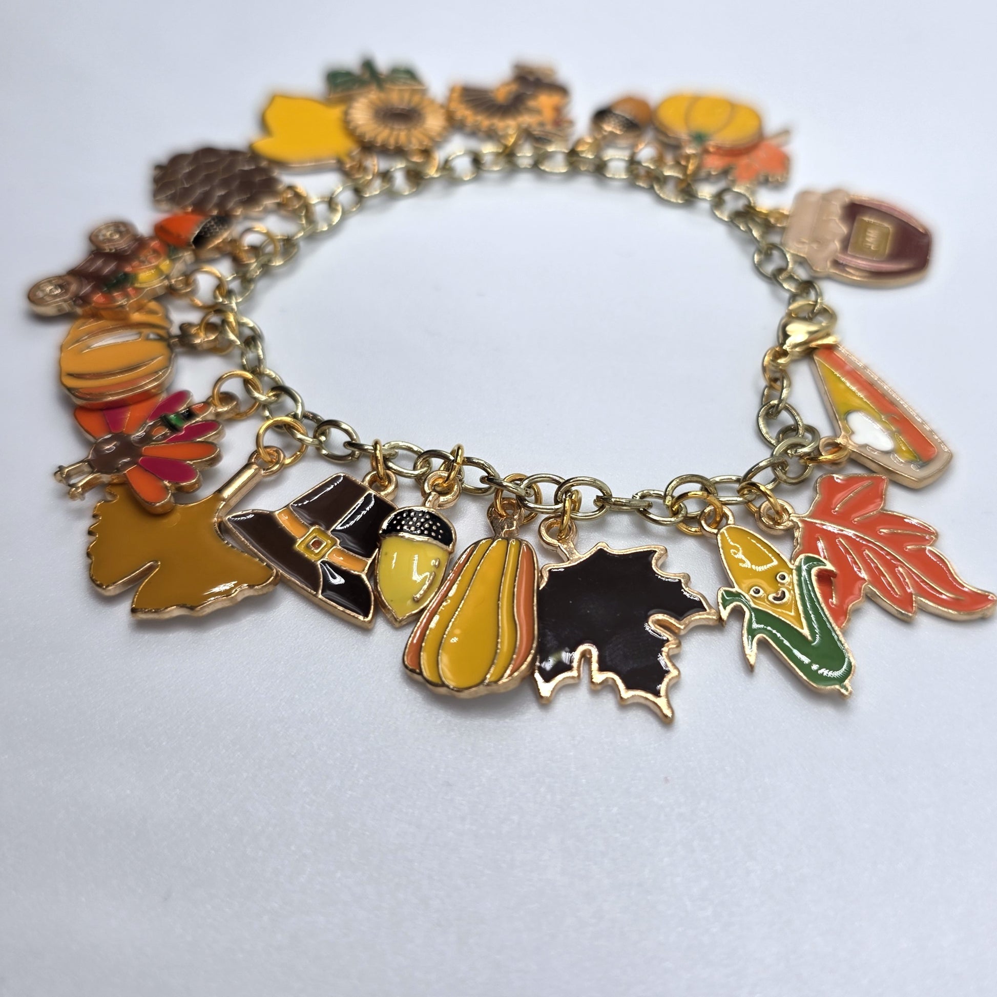 Bracelet with autumn-themed charms on a white background
