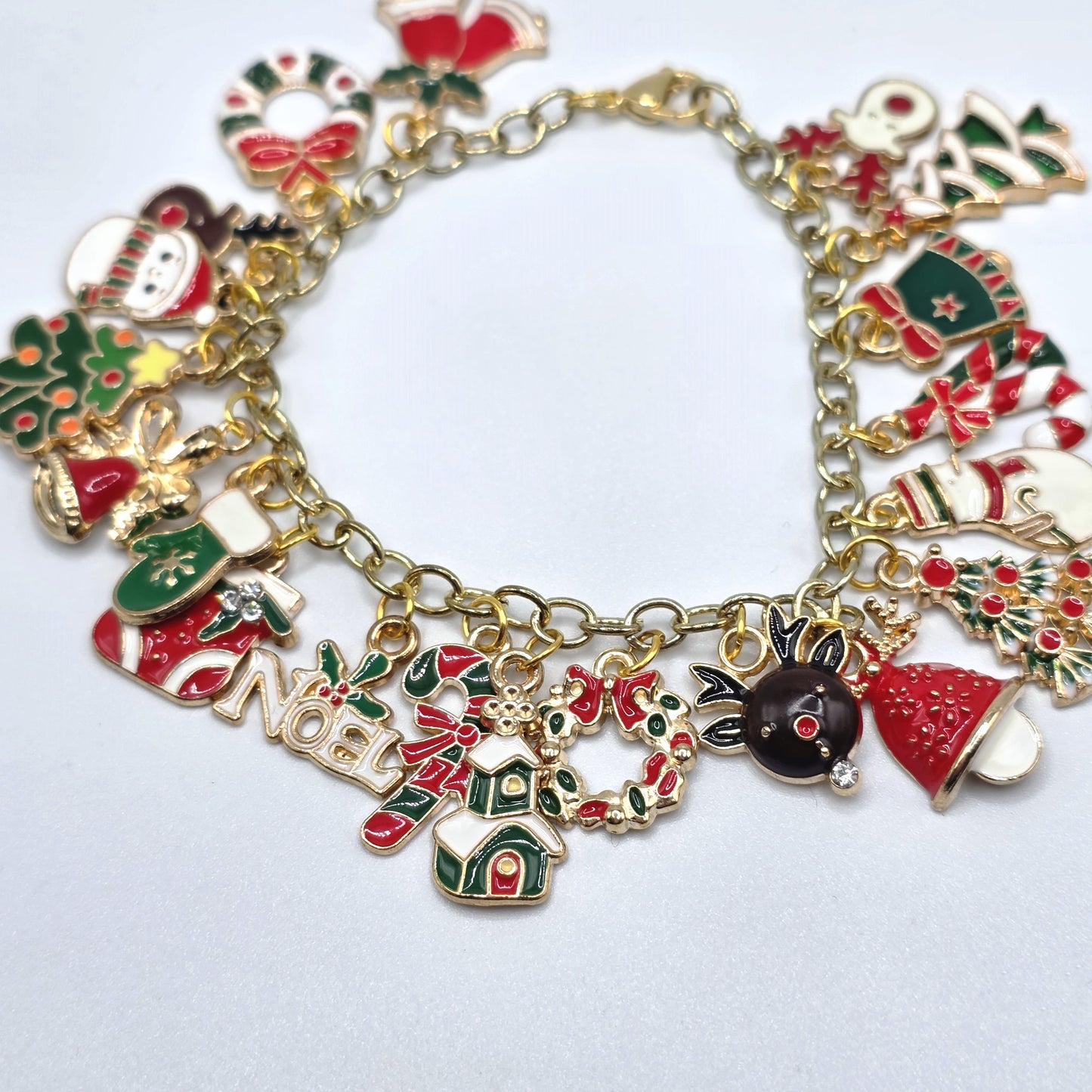 Christmas-themed charm bracelet on a light gray background