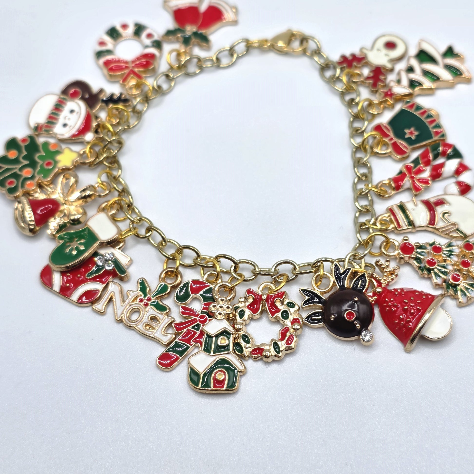 Christmas-themed charm bracelet on a light gray background