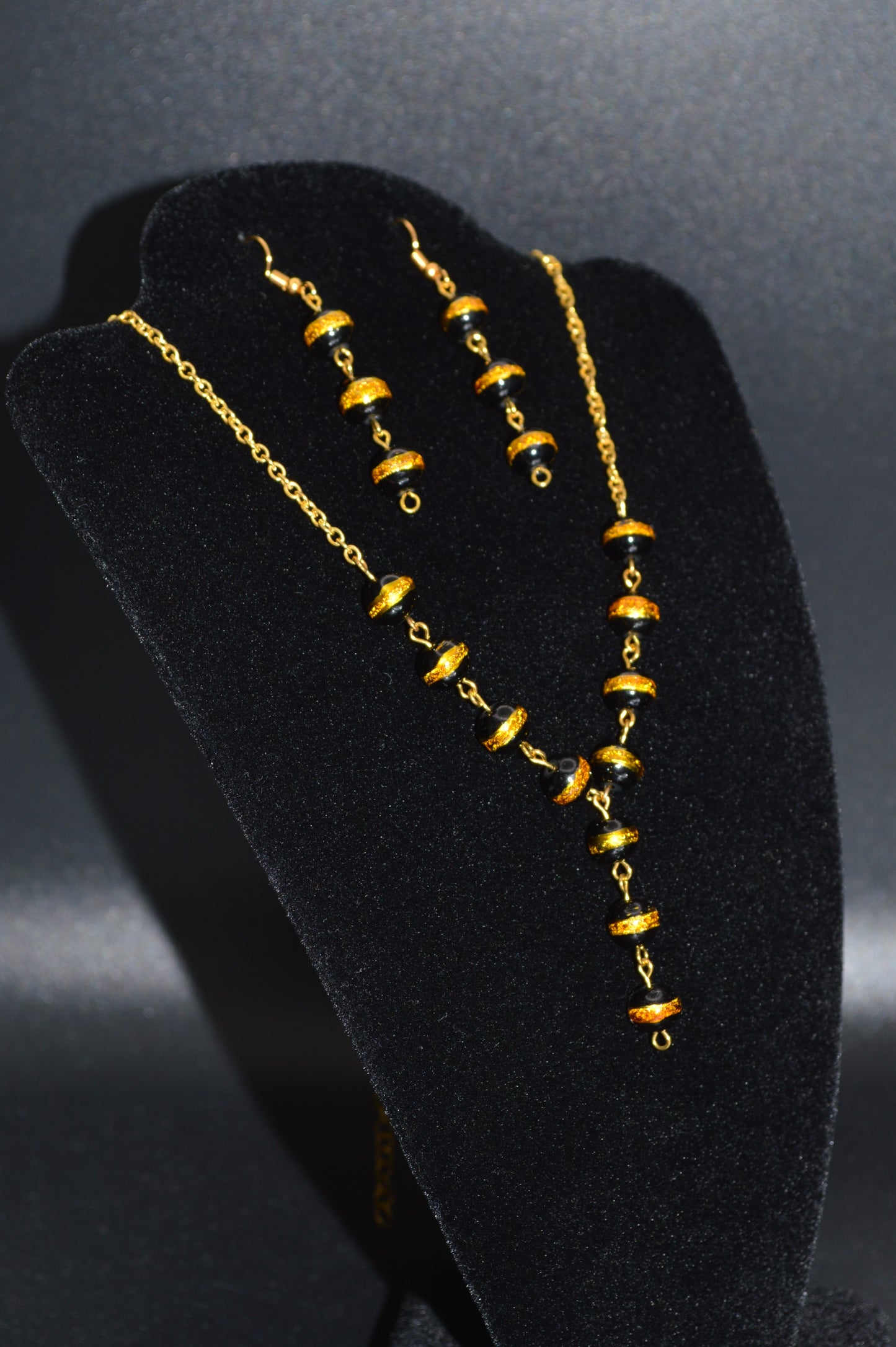 Black with a Gold Stripe Glass Beads on a Gold Chain Necklace